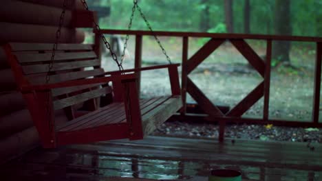 Log-cabin-porch-swing-in-rain