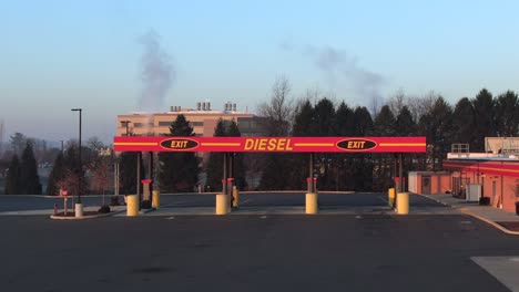Truck-diesel-gas-station-in-sunset,-sunrise,-aerial-view-of-truck-refueling-pump-in-America,-road-transportation-and-fossil-fuel-consumption-concept