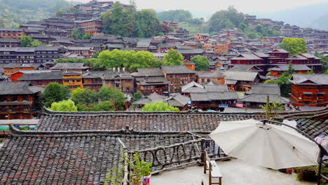 high-speed-tilting-down-shot-of-city-at-Qiandongnan,-Guizhou-province,-China