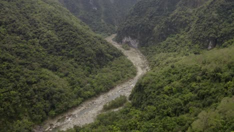 Taroko-Valley-aerial-view-above-curved-mountain-woodland-wilderness-river-through-dense,-fresh,-forestry