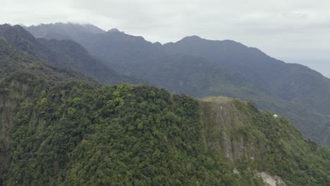 Aerial-view-rising-above-tropical-green-Taroko-Valley-dense-jungle-woodland-mountain-peaks
