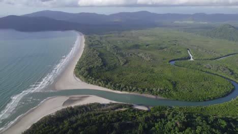 Aerial-View-Over-River-Flowing-Through-The-Ocean-In-Daintree-National-Park,-Far-North-Queensland,-Australia---drone-shot