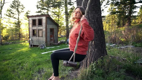 Country-girl-going-gaga-on-a-swing-at-Red-Lodge-Montana-woods