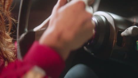 Close-up-of-a-woman's-hands-on-a-tuner-car's-steering-wheel