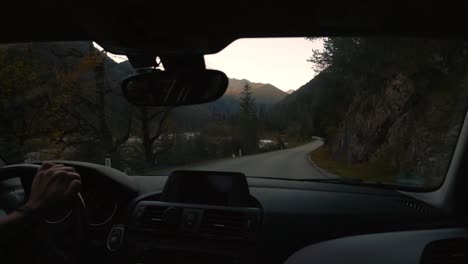 POV-point-of-view-car-drive-in-Alps-valley-mountain-peaks-in-Austria-Tyrol-with-romantic-and-scenic-road-in-natural-landscape