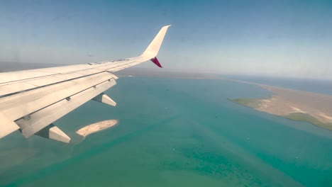 shot-from-the-airplane-window-during-landing-in-the-bay-of-los-cabos-mexico