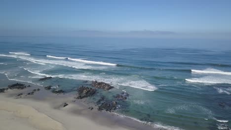 some-surfers-enjoying-the-perfect-waves-on-the-beach-at-Praia-da-arda,-afife,-Viana-do-Castelo