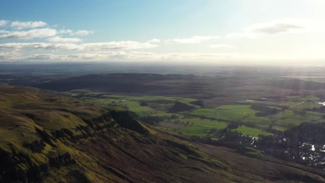4K-Aerial-angle-flying-over-the-Campsie-Hills-above-Strathblane,-drone-shot-during-sunny-day-in-Stirlingshire-countryside