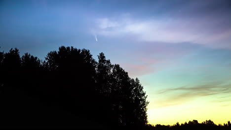 Comet-NEOWISE-flying-at-sky-during-yellow-sunrise-in-nature-woodland,time-lapse