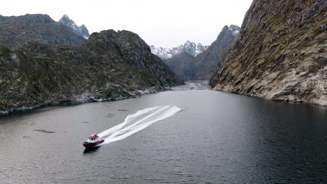 Boat-speeds-along-Trollfjord---famous-tourist-attraction-in-arctic-Norway