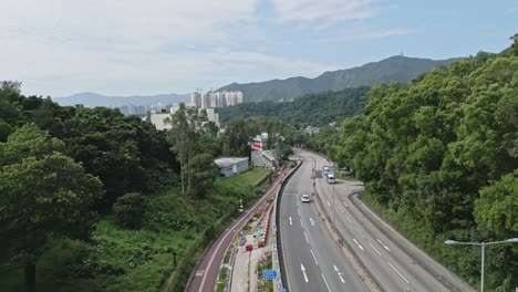 Ting-Kok-Road-towards-the-Tai-Po-East-Fire-Station,-aerial-dolly-in