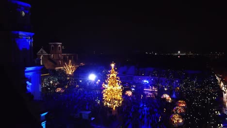 Christmas-market-of-Kaunas-city-with-glowing-tree,-aerial-static-view