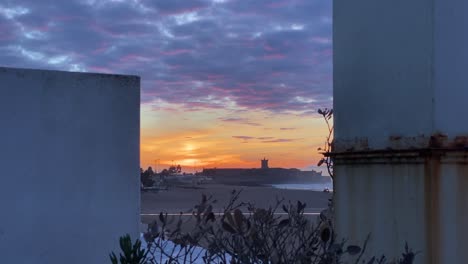huge-sunrise-over-Carcavelos-beach-seen-between-two-chimneys