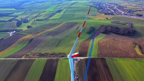 Construction-Of-A-Wind-Turbine-In-Scenic-Landscape---aerial-drone-shot