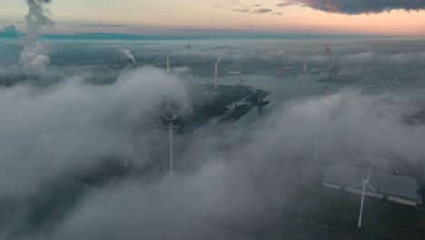 Curious-drone-flight-at-port-of-Vlissingen-above-temperature-inversion---view-of-many-wind-turbines,-Zeeland,-Netherlands