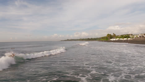 Surfers-Surfing-and-Catching-A-Wave-at-a-Beach-in-Bali