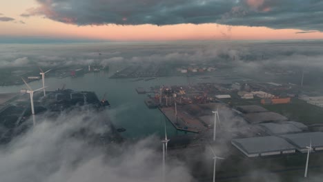 Cinematic-Aerial-Drone-Shot-fo-Wind-Farm-at-the-Port-of-Vlissingen,-Netherlands-Above-the-Clouds-During-Sunset