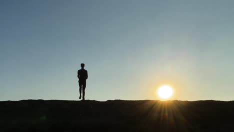Skinny-young-man-exercising-jogging-in-place-at-sunrise
