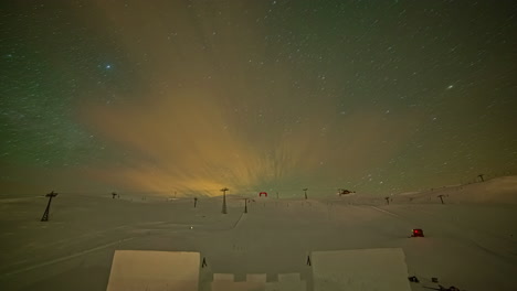Night-timelapse-shot-of-star-movement-over-snow-covered-mountain-slope-at-night-time-before-dawn