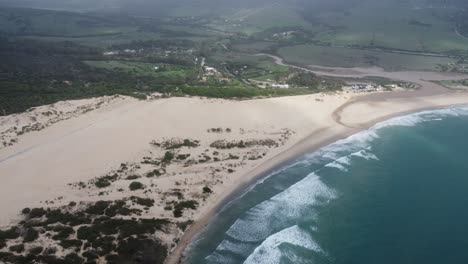 impressive-sand-dune-at-valdevaqueros-beach-near-famous-tarifa-town-in-the-south-of-spain,-droneshot