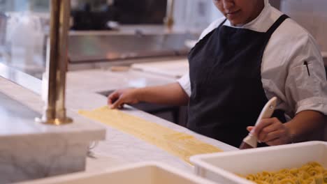 Female-chef-brushing-handmade-lasagna,-medium
