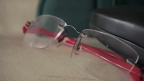 Close-up-of-a-pair-of-prescription-glasses-with-red-legs