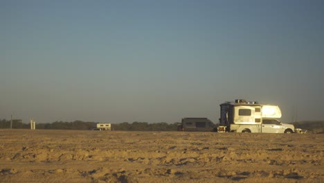 Beach-campers,-vans,-and-trucks-at-sunset-on-Assateague-Island-National-Park
