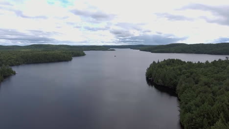 Wide-Angle-of-Drone-Flying-Up-Over-a-Lake-in-the-Summer