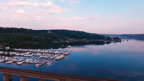 Drone-Flying-Aerial-View-Bridge-Boats-Marina-Water-River-Trees-Hills-CLouds-Sky-Country-Side