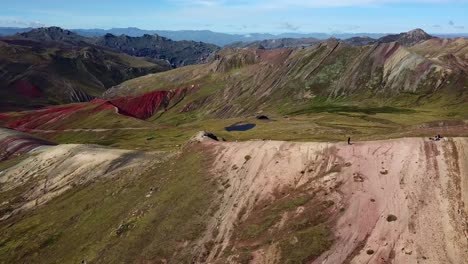 Aerial,-orbit,-drone-shot-of-people-hiking-on-the-Palcoyo-rainbow-mountain,-in-Valle-Rojo,-Andes,-Peru,-South-America