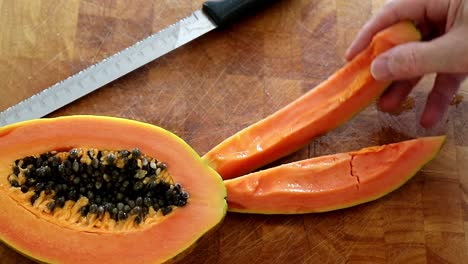 Removing-Red-Papaya-slices-from-the-cutting-board