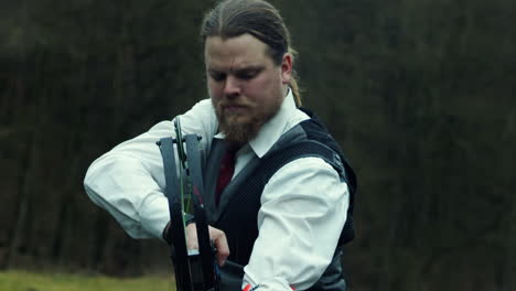 Business-man-in-dress-shirt-vest-and-tie-draws-bow-and-arrow,-120fps