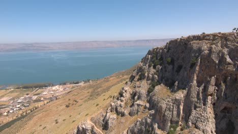 Aerial-drone-shot-showing-mount-arbel-rock-and-sea-of-galilee-in-historic-Israel