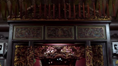 Inside-Taiwan-temple-ornate-decorative-colourful-weave-fabric-tilt-down-to-incense-burner---candles-altar-shrine