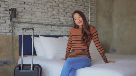 Slowmotion-on-Asian-girl-tourist-who-has-just-arrived-at-her-hotel-room-with-her-baggage-bag