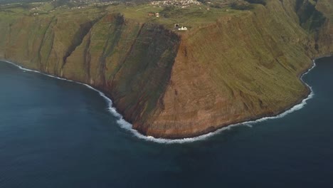 Aerial-view-of-the-shore-line-in-ponta-do-Pargo-and-view-of-the-light-house,-Calheta,-Madeira-island,-Portugal