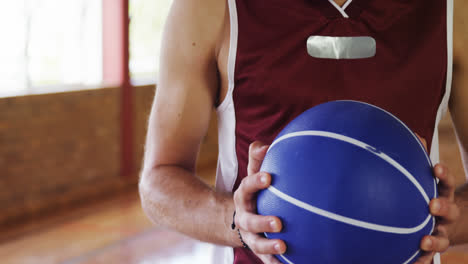 Determined-basketball-player-holding-a-basketball