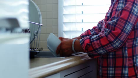 Senior-woman-washing-utensils-at-home
