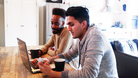 Gay-couple-using-laptop-while-having-coffee
