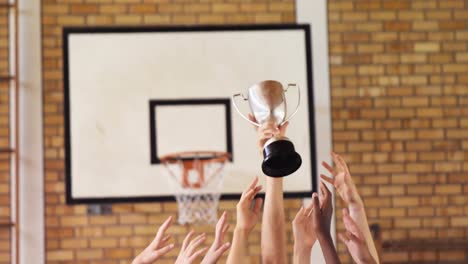 High-school-kids-holding-trophy-in-basketball-court