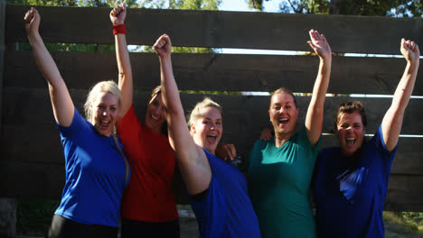 Portrait-of-happy-women-cheering-during-obstacle-course