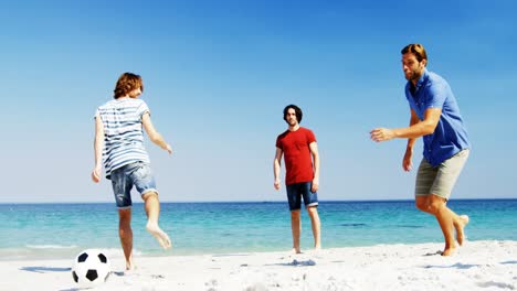 Friends-playing-football-at-beach