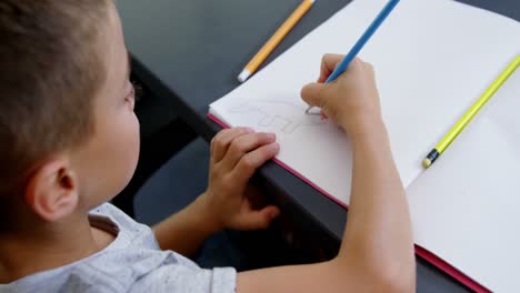 Boy-drawing-in-book