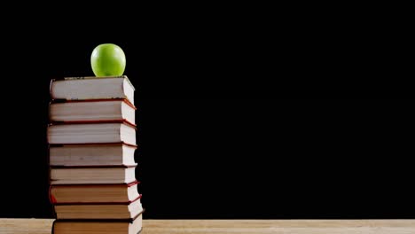 Green-apple-on-book-stack