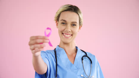 Nurse-showing-breast-cancer-awareness-ribbon