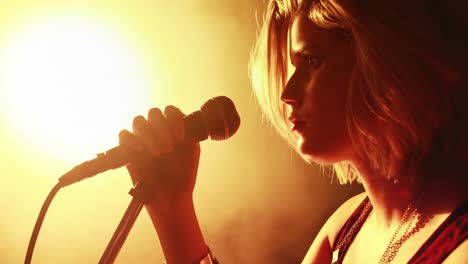 Female-singer-singing-into-a-microphone-4k