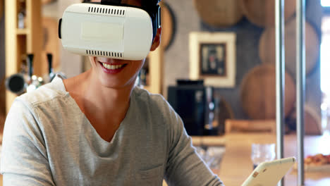 Man-using-virtual-reality-headset-and-digital-tablet-in-restaurant-4k