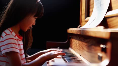 Schoolgirl-learning-piano-in-music-class-4k