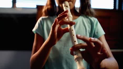 Schoolgirl-playing-flute-in-music-class-4k