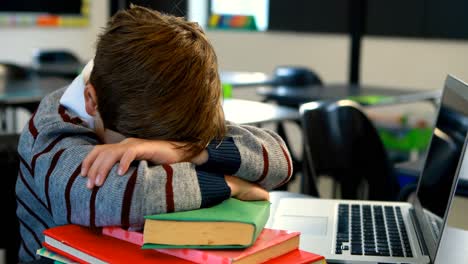 Tired-schoolboy-sleeping-in-classroom-4k